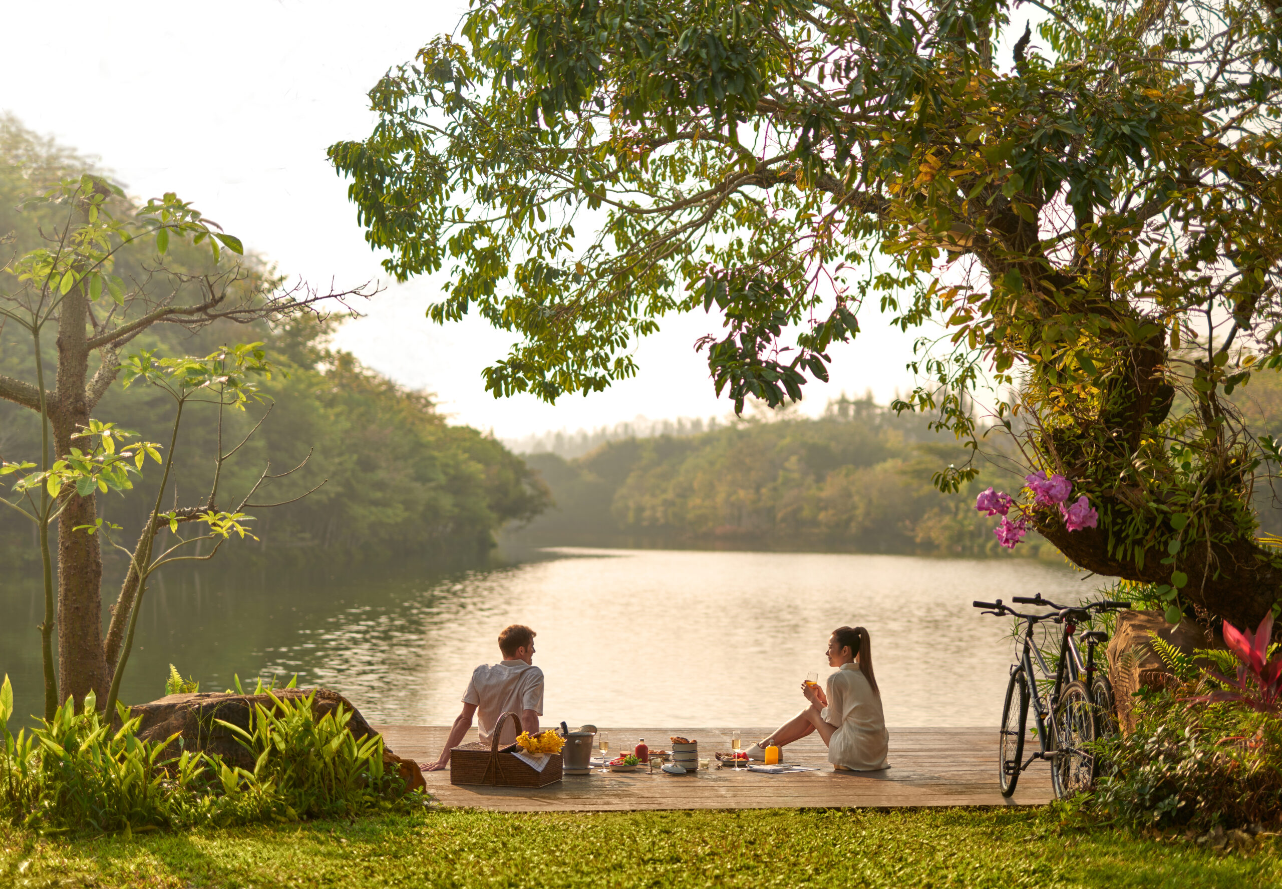 a couple and outdoor picnic by the swan lake view