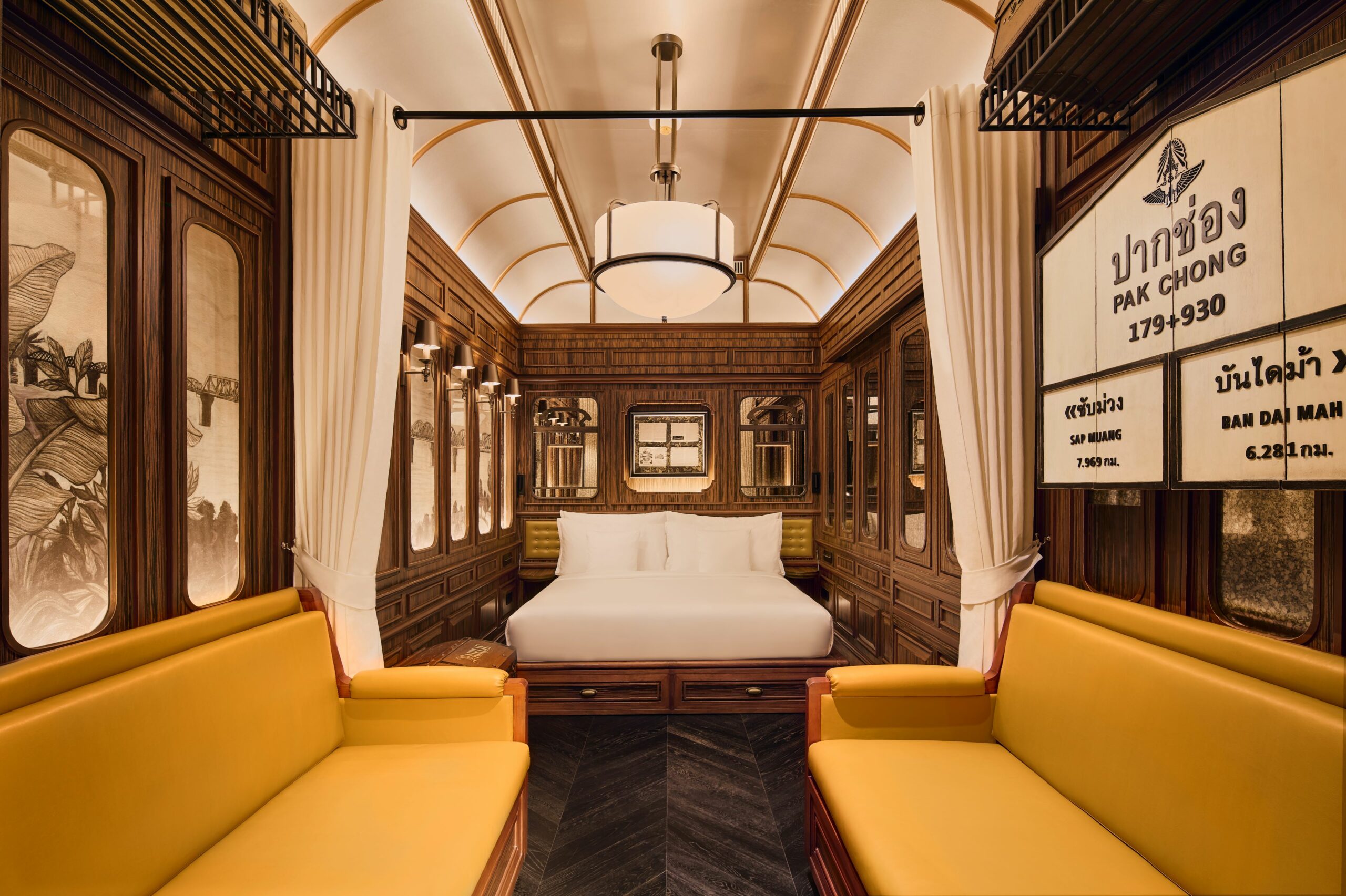 a brown and white train-themed hotel suite with gold loveseats at intercontinental khao yai resort