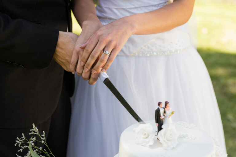 groom and bridge cutting a cake together