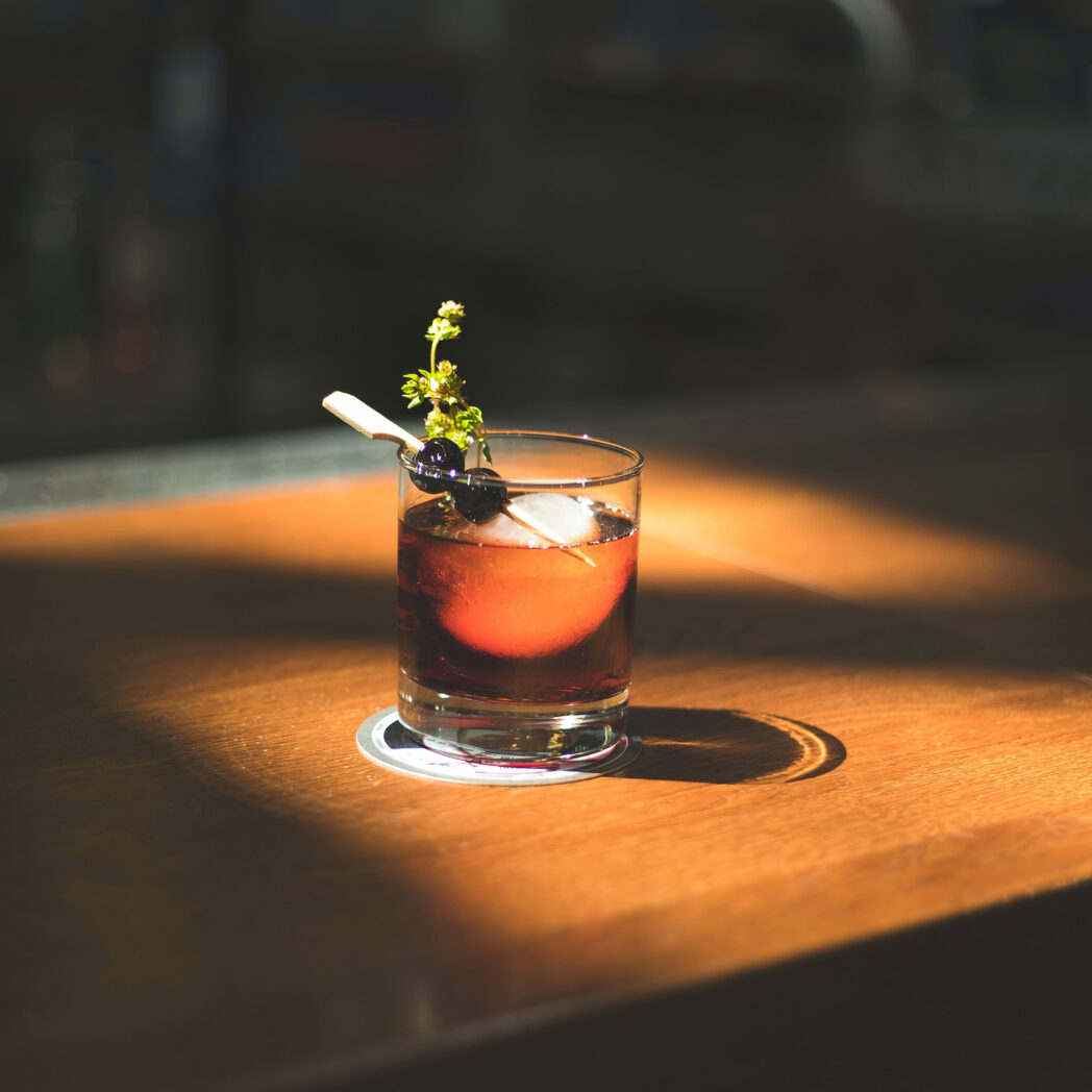 cocktail with garnish on an atmospheric tabletop