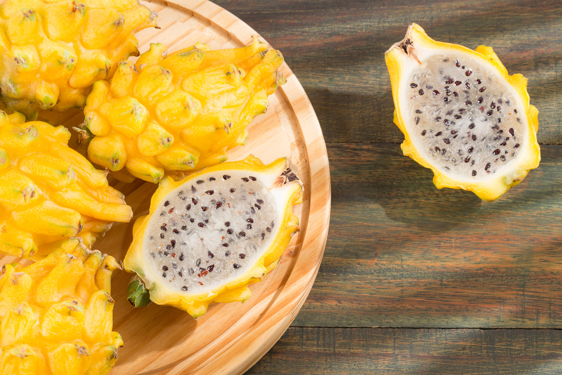 yellow dragon fruit on a wooden tray