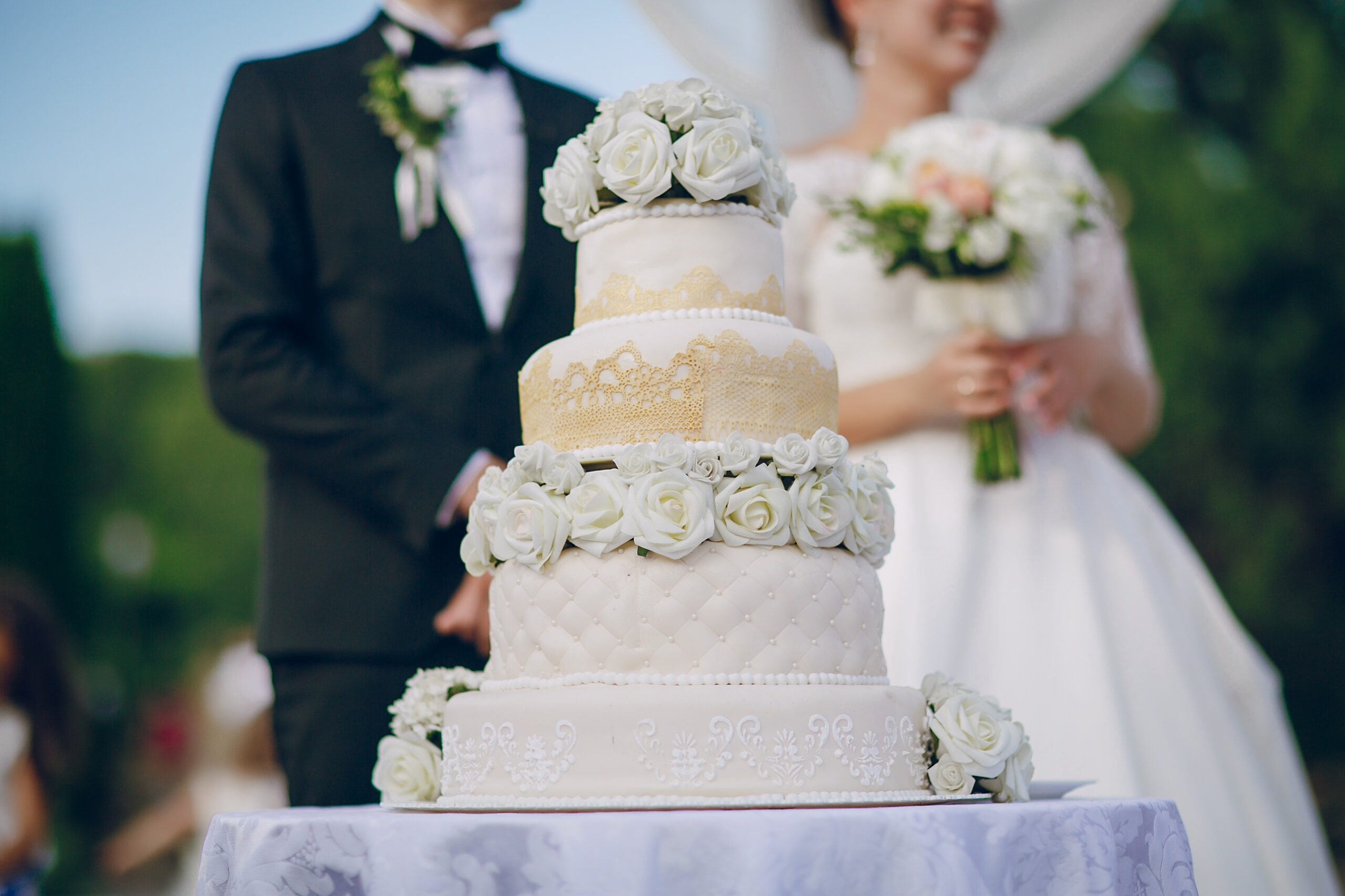groom and bridge standing behind their cake
