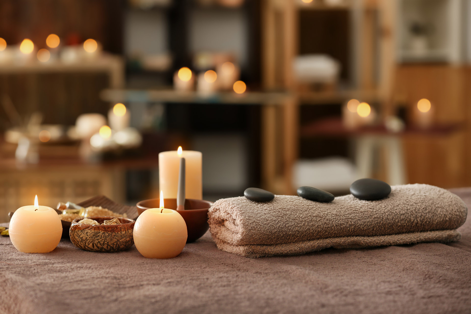 candles, towel and stones for massage