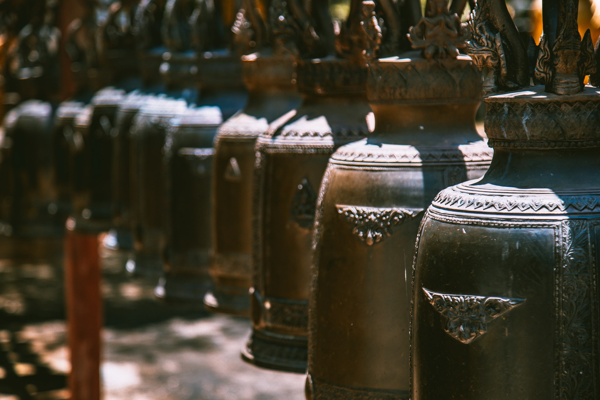 a row of bells at a buddhist temple in korat