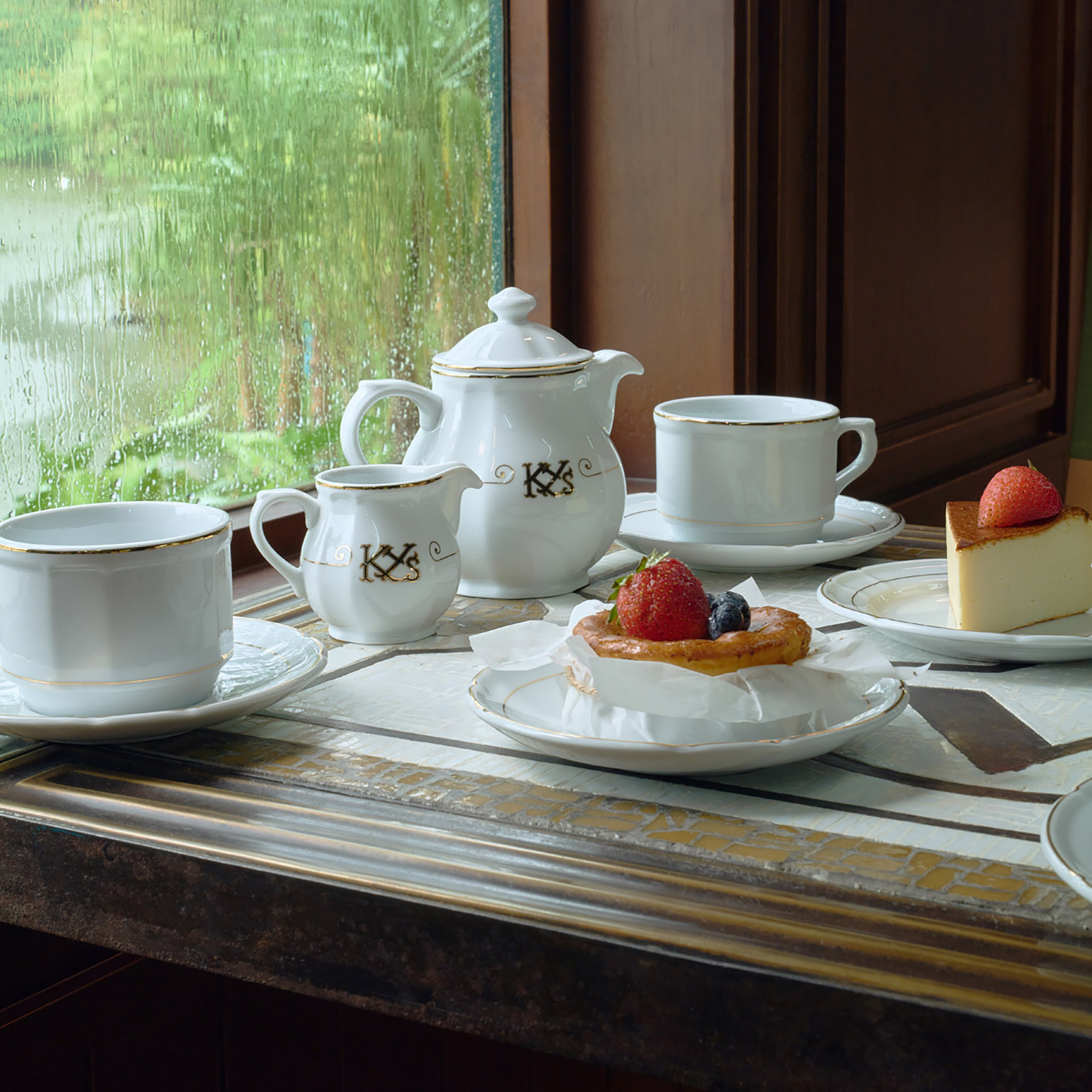 tabletop white porcelain tea set with pastry
