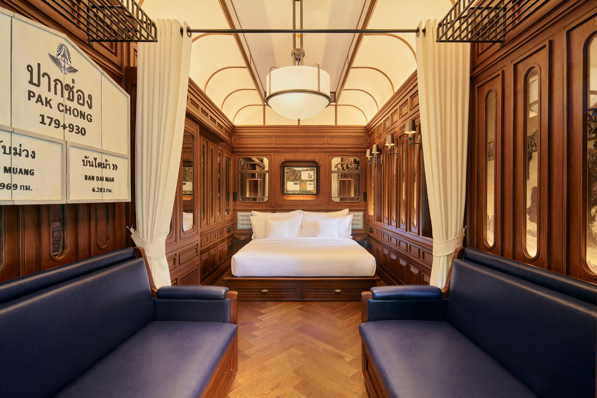 a brown and white train-themed hotel suite with blue loveseats at intercontinental khao yai resort