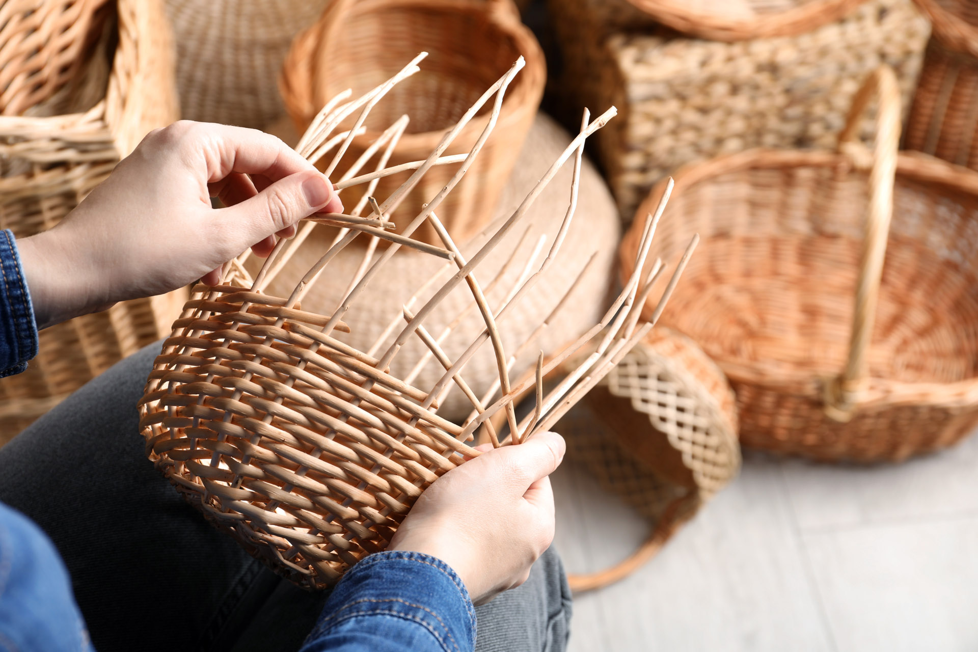 closeup of a woman weaving baskets
