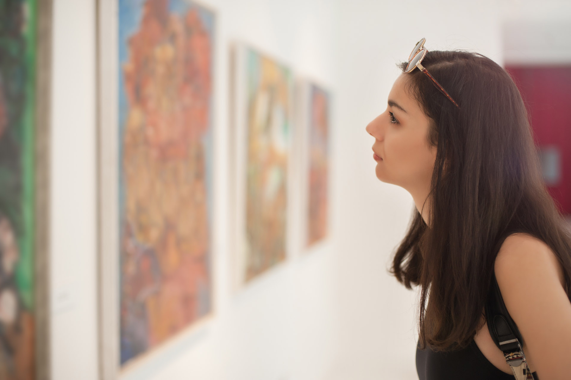 woman looking at a painting in an art gallery